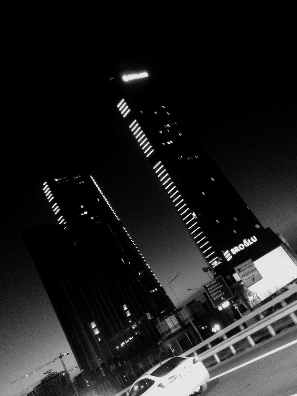 LOW ANGLE VIEW OF ILLUMINATED BUILDINGS AGAINST CLEAR SKY