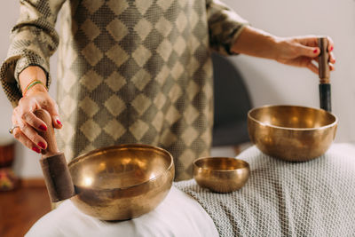 Woman playing tibetan singing bowl in sound healing therapy