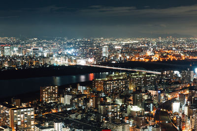 High angle view of illuminated city buildings at night