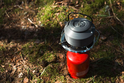 Close-up of watering can on field