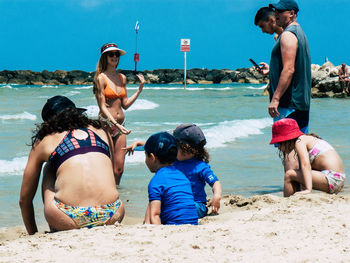 Full length of friends on beach