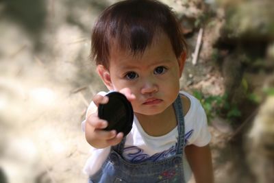 Portrait of cute girl holding outdoors