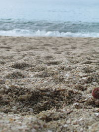 Close-up of wave on beach against sky