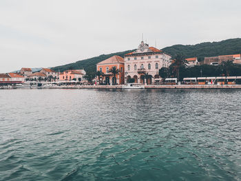 Town by sea against clear sky