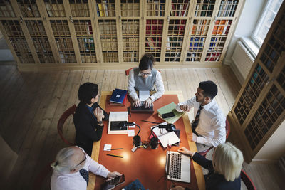 High angle view of lawyers researching at table in board room