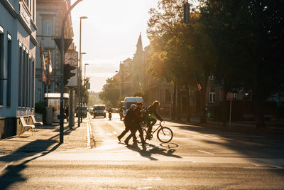 People riding bicycle on street in city