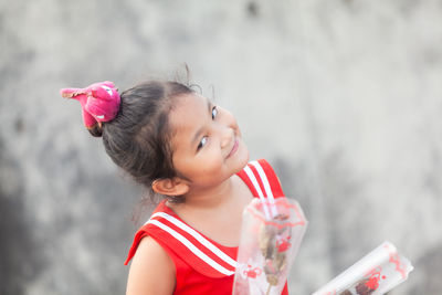 Portrait of cute girl against blurred background