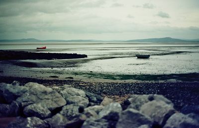 Scenic view of sea against cloudy sky