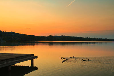 Scenic view of lake against sky during sunset