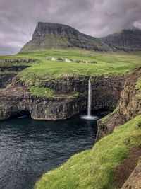 Scenic view of waterfall against sky