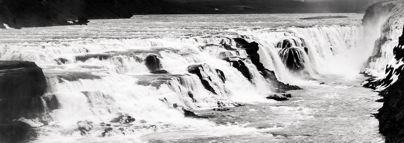 Scenic view of waterfall against sky