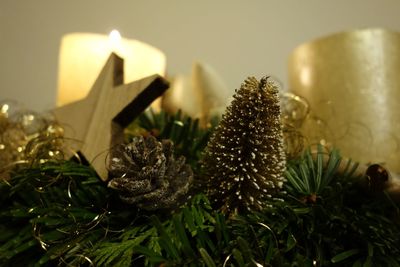 Close-up of christmas decoration with one burning candle