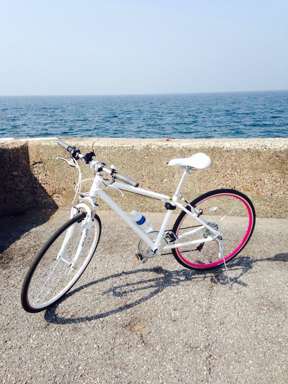 bicycle, clear sky, beach, transportation, sea, copy space, horizon over water, sand, water, mode of transport, shore, tranquility, stationary, land vehicle, tranquil scene, day, parking, no people, nature, outdoors