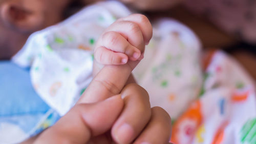 Close-up of baby boy on bed