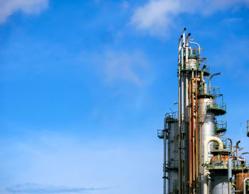 Low angle view of factory against blue sky