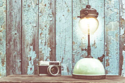 Close-up of electric lamp hanging on table