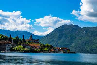 Scenic view of river and mountains against sky