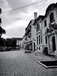 Street amidst buildings in city against sky