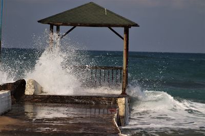 Water splashing in sea against sky