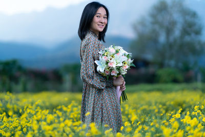 Beautiful woman standing on field