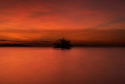 Scenic view of sea against romantic sky at sunset