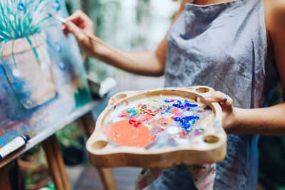 Woman painting on easel