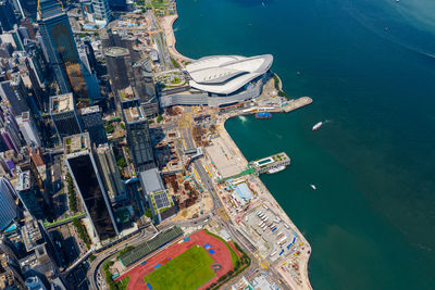 Aerial view of city by sea against sky