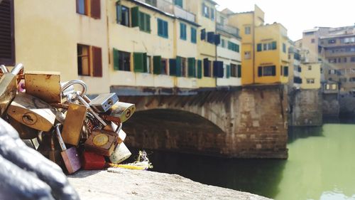 Padlocks on bridge over canal in city