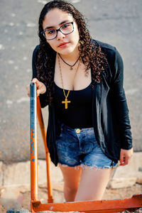 Portrait of beautiful young woman standing outdoors