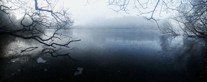 Close-up of snow on lake against sky