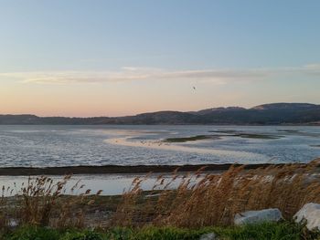 Scenic view of sea against sky at sunset