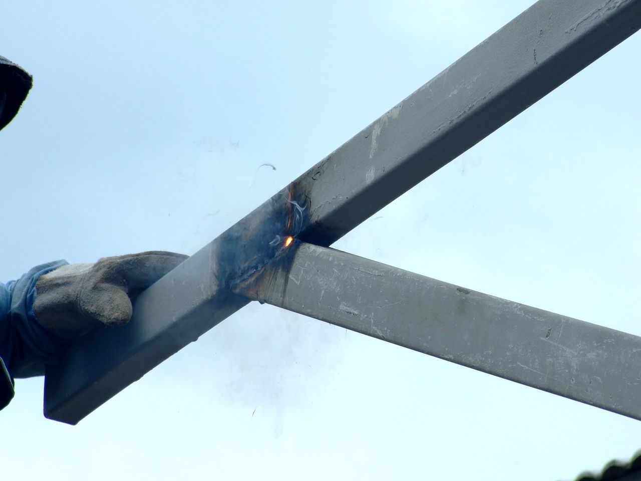 LOW ANGLE VIEW OF METAL STRUCTURE AGAINST SKY