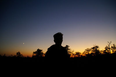 Silhouette man against clear sky during sunset