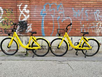 Bicycle parked against brick wall