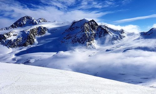 Snow covered mountains against sky