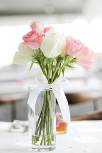 Close-up of roses in vase on table at wedding ceremony