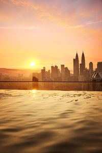 Morning scene from rooftop swimming pool to of kuala lumpur business district. 