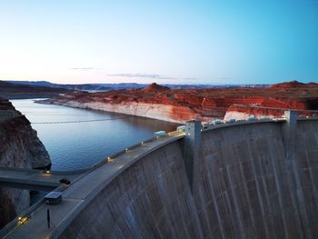 View of dam by river against clear sky