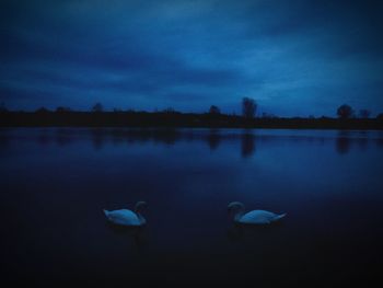 Scenic view of lake against cloudy sky