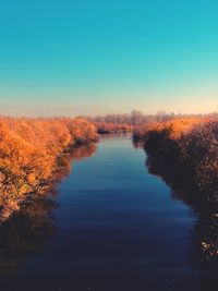 Scenic view of lake against clear blue sky