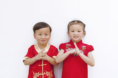 Portrait of cute boy against white background