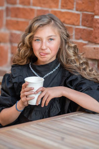 Portrait of girl drinking coffee