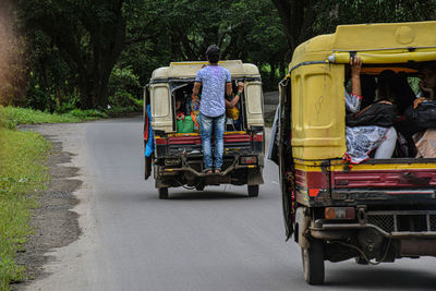 Rear view of people on road