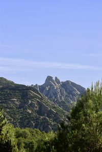 Scenic view of mountains against blue sky