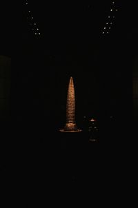 Illuminated lamp in building at night