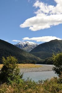 Scenic view of lake and mountains against sky