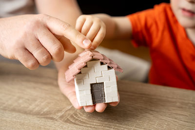 Cropped hands of woman with toy blocks on table