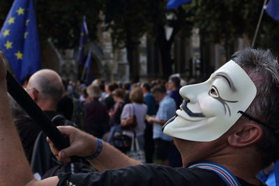 Man wearing mask on street in city