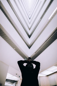 Midsection of woman standing in modern building