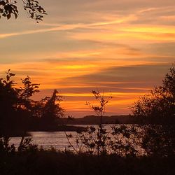 Scenic view of lake against orange sky